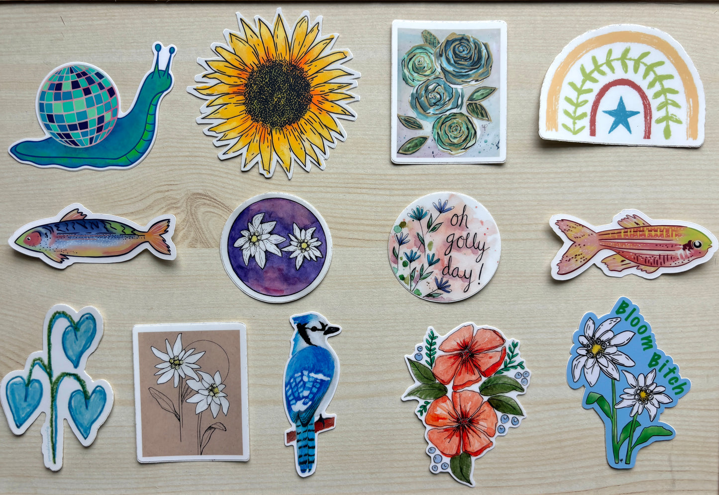 Collection of variously shaped and colored stickers on a wooden surface