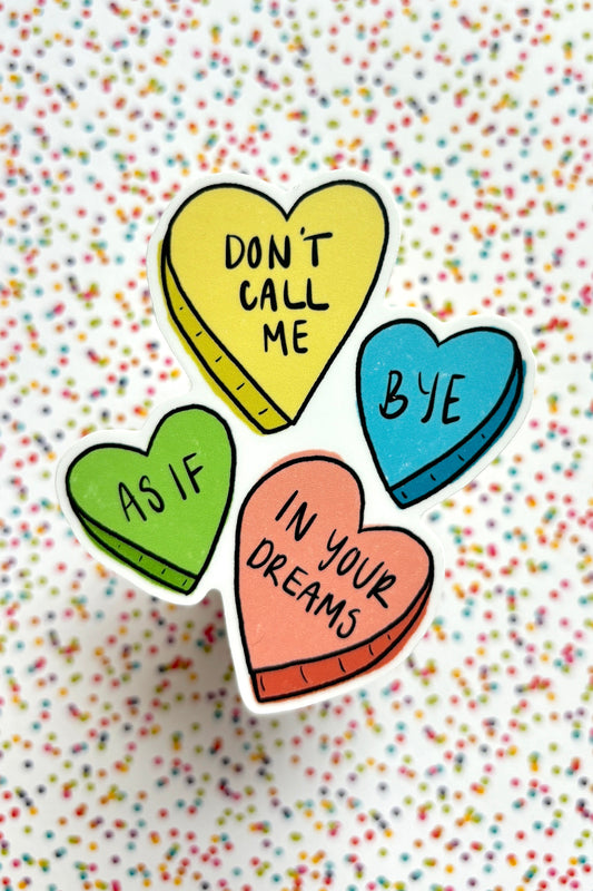 Colorful heart-shaped pins with text on a multicolored confetti background